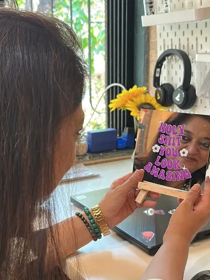 A closer look at the affirmation mirror on its wooden stand. It's a small detail that makes a big difference.