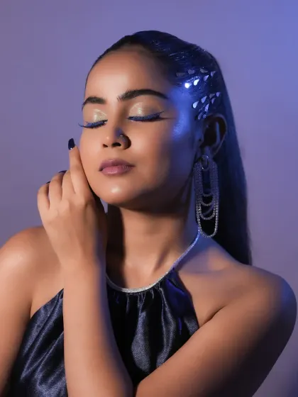 A serene, eyes-closed pose that showcases the sharp, electric blue winged liner. Precision is a skill I drill into all my students.