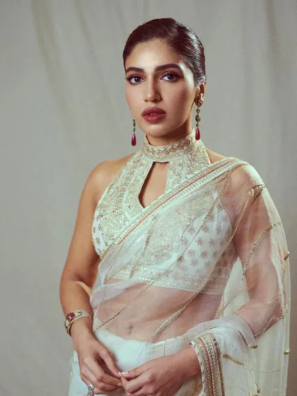 A close-up of Bhumi's ivory saree look, highlighting the intricate embroidery on the halter-neck blouse and the elegant, sheer fabric of the saree.