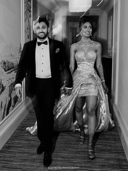A fun, motion-blur shot of the couple walking down a hotel corridor in Baku, capturing their vibrant energy.