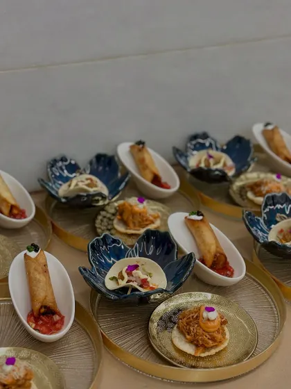 A platter of second-course appetizers, including Crunchy Avocado Tacos, Pulled Jackfruit Tostadas, and Black Bean & Sweet Corn Taquitos, each plated with precision.
