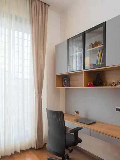 This view highlights the overhead storage, which includes a mix of closed cabinets and open shelves with glass doors. It’s a perfect balance of concealed and display storage.