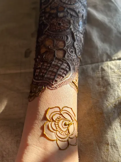 A close-up of the details, with a single rose drawn on the wrist to start the design.