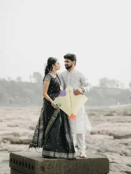 A classic portrait with the kite. This photo beautifully captures the essence of the festival and the couple's connection.