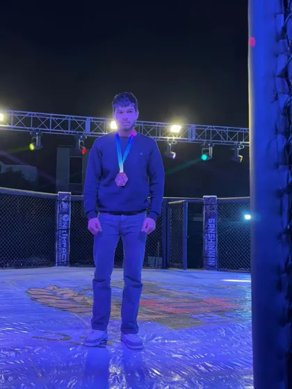A champion stands alone in the octagon after a hard-fought victory at Elite Combat MMA in Ajmer, a testament to individual dedication and team support.