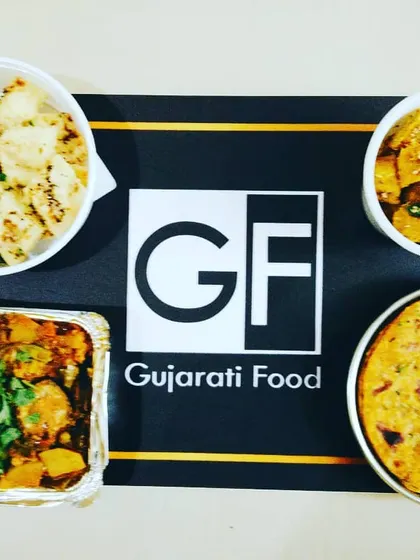 This is an example of a complete meal I can provide for your event. It features my special Undhiyu, soft Dhokla, crispy Muthiya, and fresh Thepla, all packed and ready to serve.