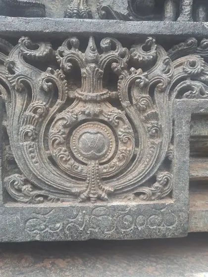 A carving at the base of a sculpture, bearing the signature of the sculptor, debunking the myth of a single artist, Jakhanacharya.