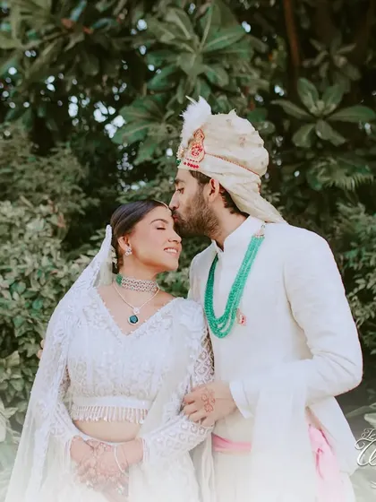 A gentle forehead kiss from the groom, a classic and timeless expression of love.