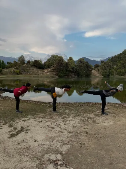 A synchronized Virabhadrasana III, or Warrior III, with fellow yogis by the Deoria Tal lake. Balancing together in nature creates a beautiful harmony between us and the serene landscape.