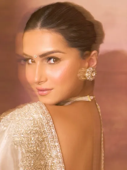 The captivating Tara Sutaria, embodying grace and elegance in our delicate Polki and pearl choker set. A vision in white.