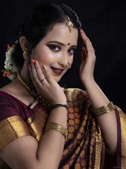 A playful and happy pose from the bride. Her makeup, featuring a bold lip and defined eyes, is designed to stay flawless through all the smiles and emotions of the wedding day.