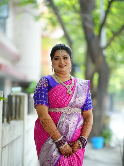 A full-length shot showing the complete engagement look. The makeup is balanced to complement the bright colors of the saree without being overpowering.