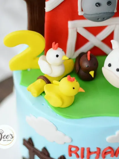 The little fondant chicks and the number '2' add a personalized touch to this farm cake.
