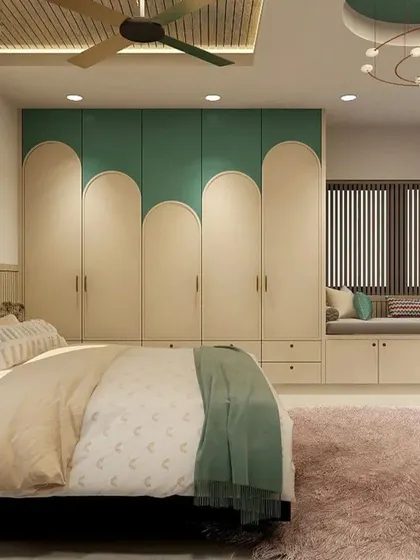 A full view of a bedroom featuring a custom wardrobe with a unique curved design in green and cream. The room also includes a cozy window seat, making it a perfect spot for reading and relaxing.