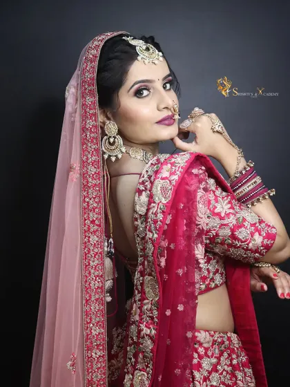 A beautiful side profile showcasing the complete bridal look. The dupatta draping, hairstyle, and makeup all work in harmony to create a stunning silhouette.