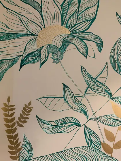 A detailed shot of the emerald and gold floral mural. I added texture to the center of the flower with small dots of gold paint, creating a subtle but impactful focal point.