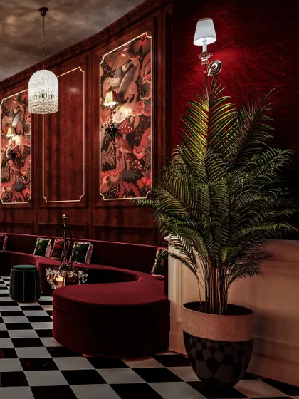 A visualization of a restro-bar in Pune, with deep red walls, serpentine seating, and custom murals. The checkerboard floor adds a classic, graphic element.