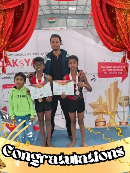 Three of our young male gymnasts with their coach, proudly displaying their certificates and medals after a successful competition. We are dedicated to developing talent in all our athletes.