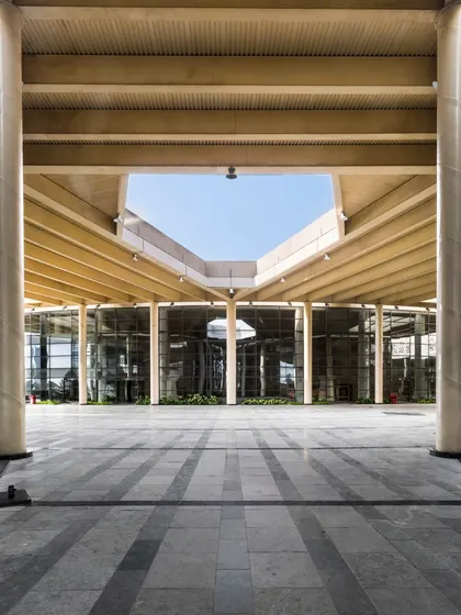 This image accompanies our thoughts on evolving architectural education. The grand, transparent entrance of this institutional building symbolizes an open and accessible approach to learning that we champion in our designs.