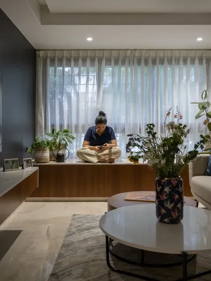 The bay window seat is a perfect spot for relaxing with a book or enjoying a cup of coffee. It's a simple feature that adds immense value and a personal touch to the living space.