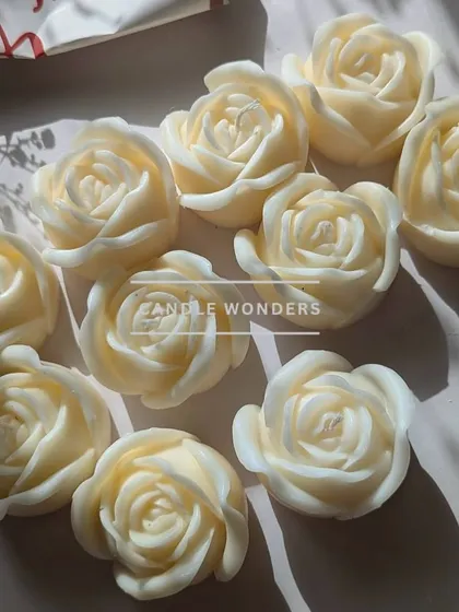 Freshly made peony and rose sculptural candles, waiting to be packaged.