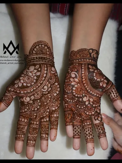 An intricate and beautiful design for Karva Chauth, with detailed patterns covering the palms.