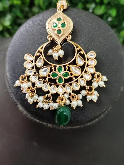 A delicate chandbali earring with green floral enamel work and pearl drops. This rental piece is fresh and pretty.