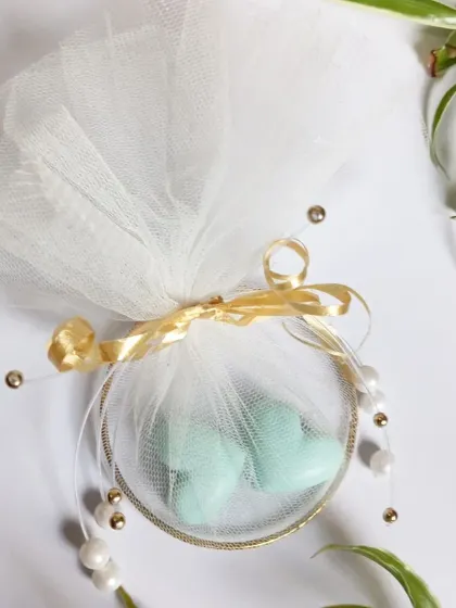 Another perspective of the wedding favor, highlighting the beautiful way the light catches the pearls and the sheer netting. I can customize these details for you.