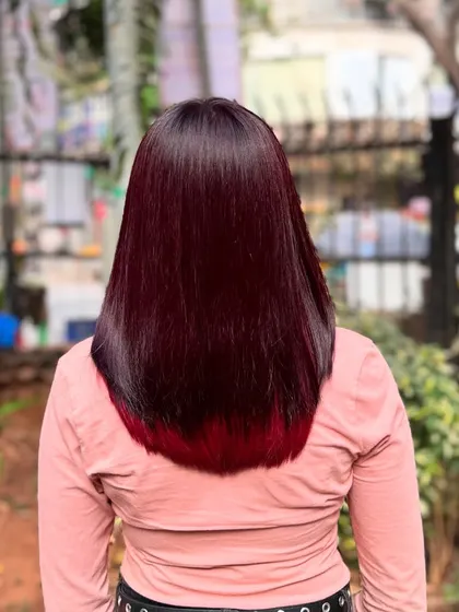 The back view shows how the bright red is hidden, creating a sleek look until the hair moves.