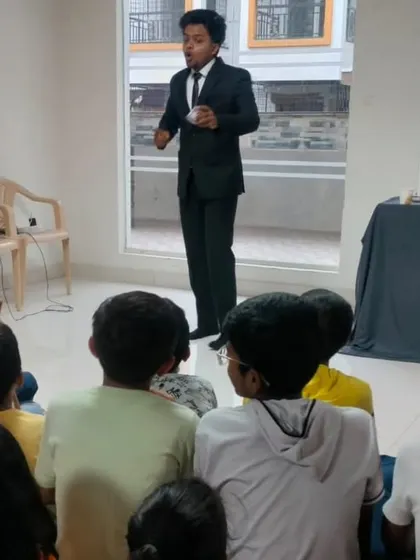 Addressing a curious audience of children sitting on the floor in a living room. I am comfortable performing in intimate home settings for family get togethers.