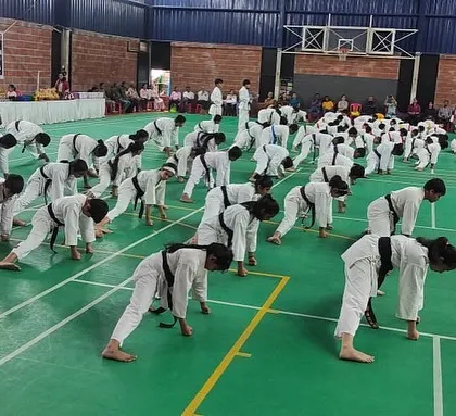 A demonstration of strength and flexibility as students perform warm-down exercises after their grading.