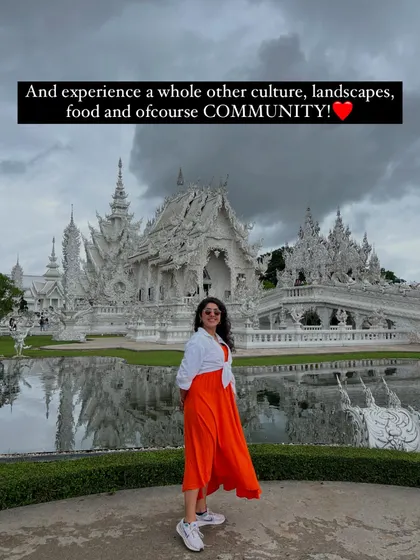 On our trips, you get to experience a whole new culture, landscape, and of course, community. Here's our host in front of a stunning white temple, ready for the next discovery.