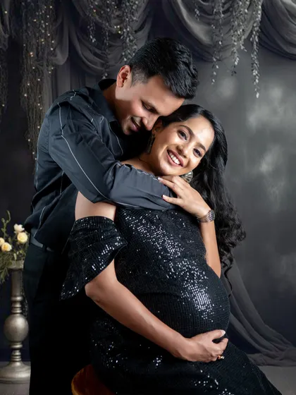 The laughter and joy between a couple are priceless. This candid moment was captured during a glamorous studio session.