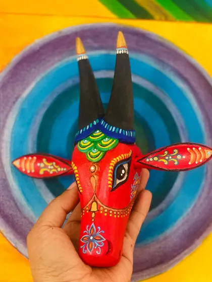 Holding the red Nandi against a colorful backdrop, this shot shows how it can complement other art in your home.