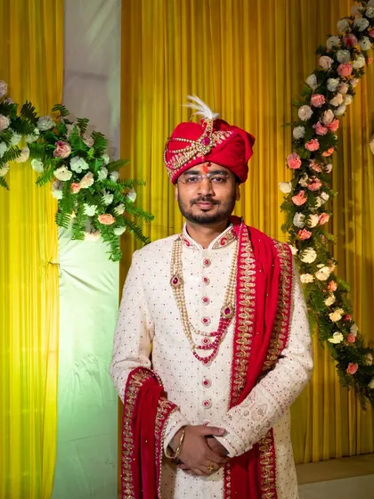 A portrait of the groom in his traditional wedding attire, looking ready for the ceremony.