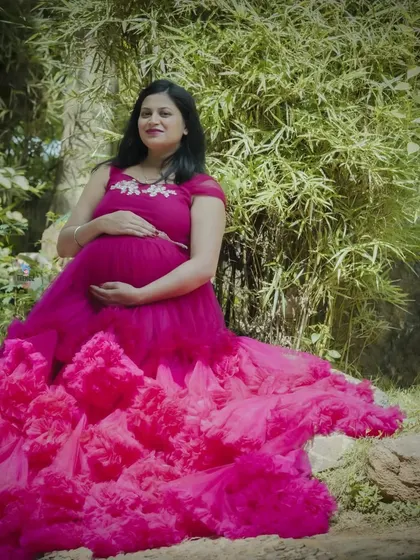 The texture of this ruffled pink gown is the star of the show. The layers create a beautiful visual effect, especially when the mom-to-be is seated.