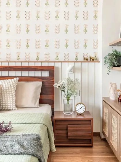 This bedroom showcases a beautiful contrast of materials. The dark wood bed and floor are balanced by light wood wicker cabinets, keeping the room feeling minimal and airy.