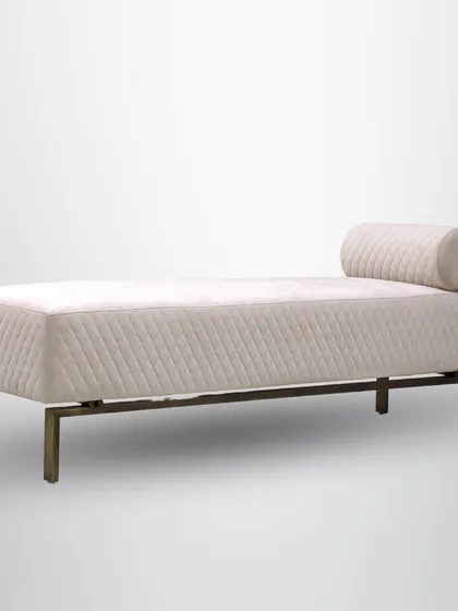 The angled view of the daybed shows its bolster pillow and clean silhouette, making it an inviting spot for a quiet afternoon.