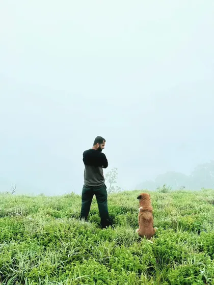 Me and a dog companion standing in a field covered in thick fog. This image, titled 'Jivanada Hudukata' (Search for Life), reflects my philosophical journey.