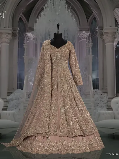 A side view of the onion pink Indo-Western outfit, highlighting its elegant silhouette and delicate embellishments.