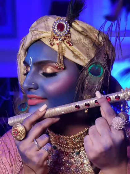 Another angle of our creative Janmashtami look, showcasing the turban, peacock feather, and golden eye makeup.