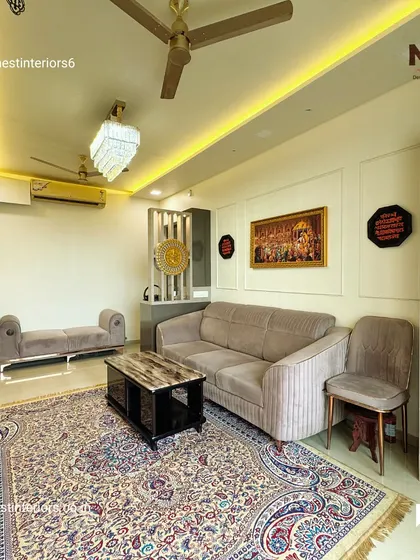 This living room from my Europa project in Dombivli features a traditional carpet that anchors the space, paired with modern sofas and a compact mandir corner for a balanced look.