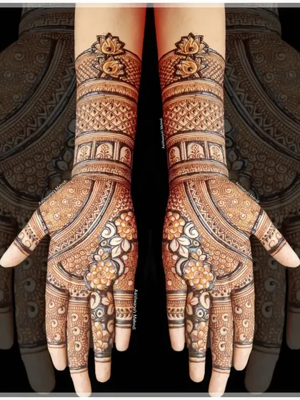 An elegant bridal design with delicate floral patterns on the palms and peacock motifs on the wrists. The fine line work is perfect for a sophisticated look.