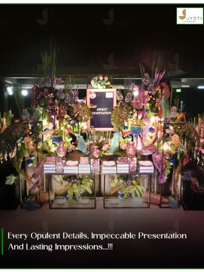 An elaborate dessert station themed 'Sweet Temptation', featuring a wild and artistic mix of florals, foliage, and unique decorative pieces for a whimsical feel.