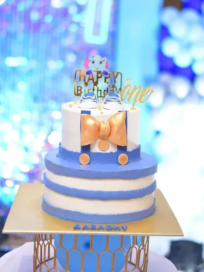 A cute cake for a first birthday, designed with a little shirt and bow tie theme.