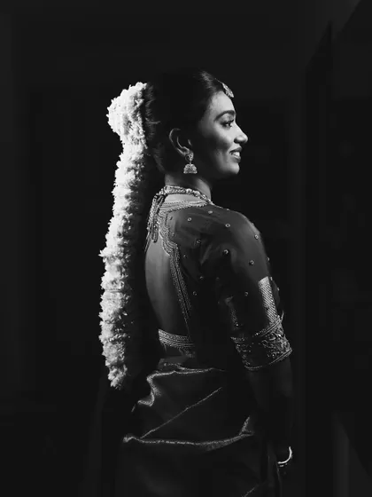The same portrait in black and white, emphasizing the classic beauty and form of the look.