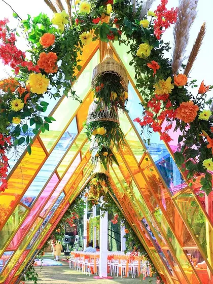 A closer look at the colorful glass panel walkway. This was a key feature of the 'Glistening Glass' Haldi, creating a stunning, rainbow-like path for the couple's entrance.