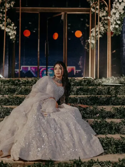 A stunning solo portrait of the bride on the stairs of her Sangeet stage.
