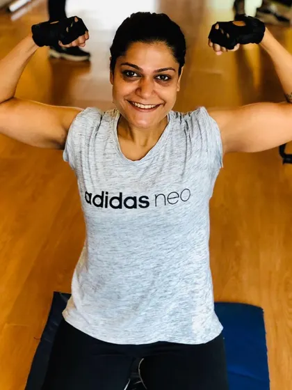 A happy client flexing after a great workout. My goal is to make you stronger and more confident, both inside and outside the gym.