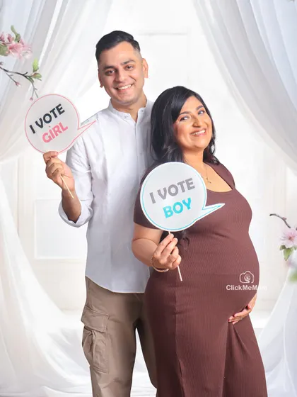 Boy or girl? The happy anticipation is a joy to capture. This couple brought these fun "I vote boy" and "I vote girl" props to their session, adding a playful touch to their pregnancy announcement photos.